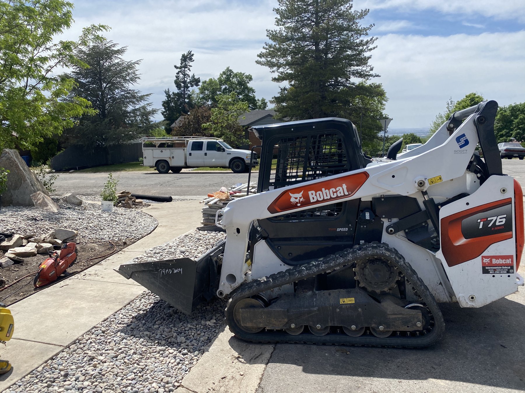 Cadoava skid steer prepping a residential driveway